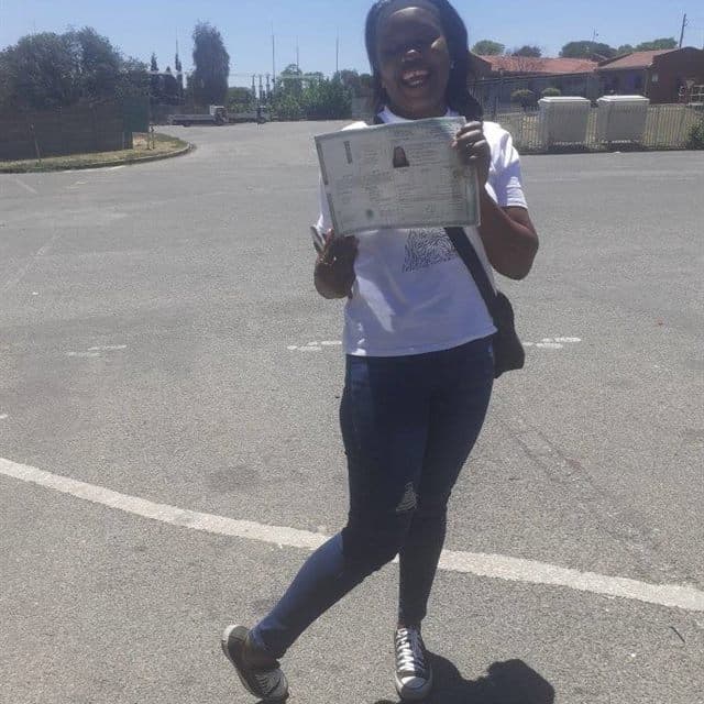 Nokuthula K holding a licence certificate after passing with Ditheto Driving Academy.